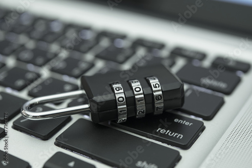 Closeup padlock on computer keyboard for concept technology data log security. photo