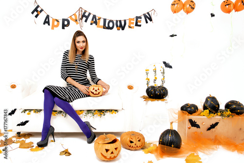 young woman with black pumking in Halloween decoration photo