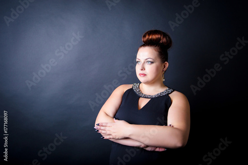 Fotografie Beautiful buxom girl in a black evening dress