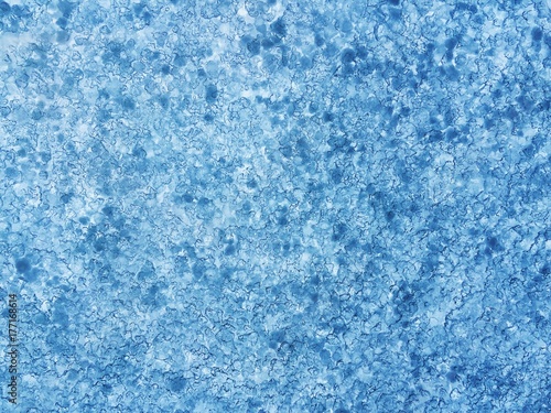 Blue ice background on the car windshield