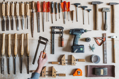 Man's hand holding a tool for woodworking photo