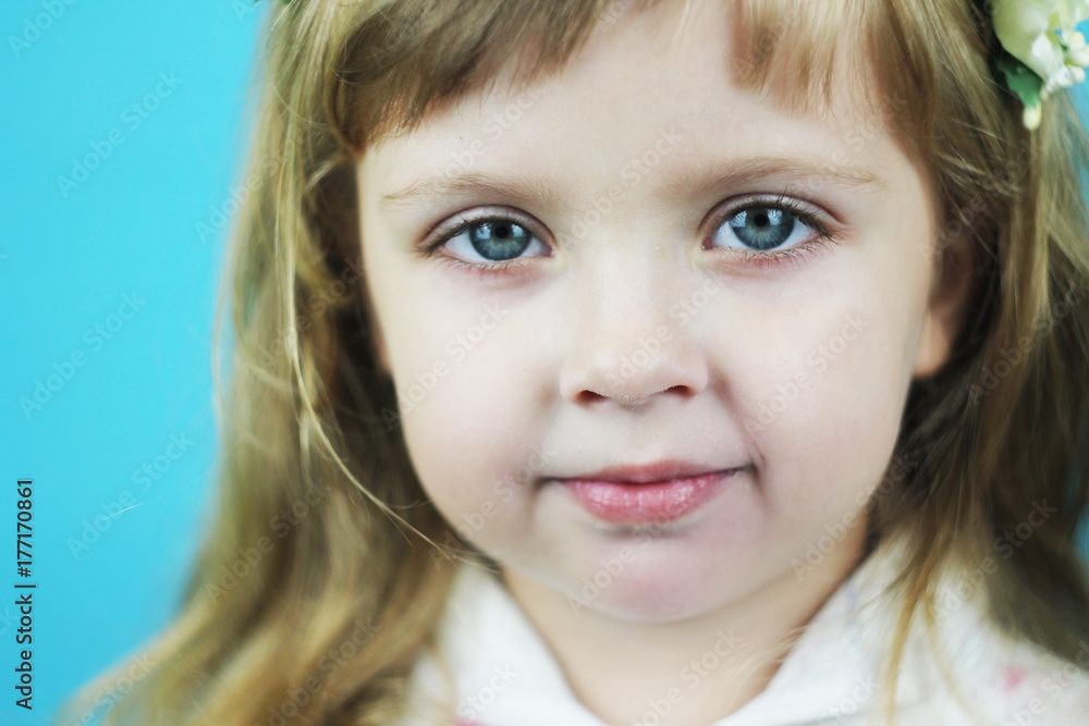 Unhappy beautiful little girl close-up with beautiful large blue eyes Unhappy beautiful little girl close-up with beautiful large blue eyes