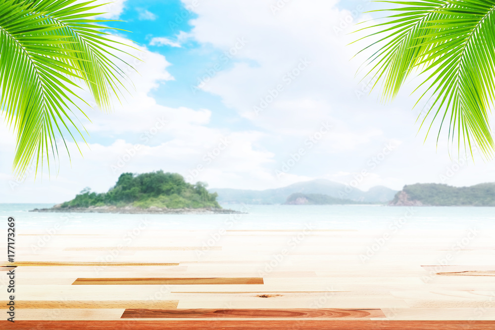 Empty wooden table and coconut leaves with party on beach blurred background in summer time. Empty wooden table and coconut leaves with party on beach blurred background in summer time.