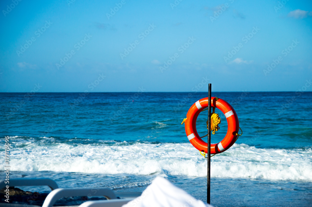 Red lifebuoy on the beach