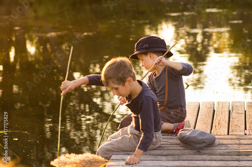 Ordinary children sitting with sticks in hands