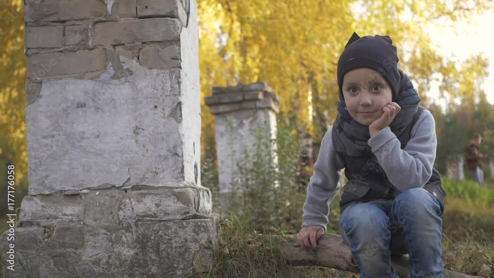 Smiling little baby boy playing in the park. Autumn. Funny cute child making vacations and enjoying Autumn. Smiling little baby boy playing in the park. Autumn. Funny cute child making vacations and enjoying Autumn.