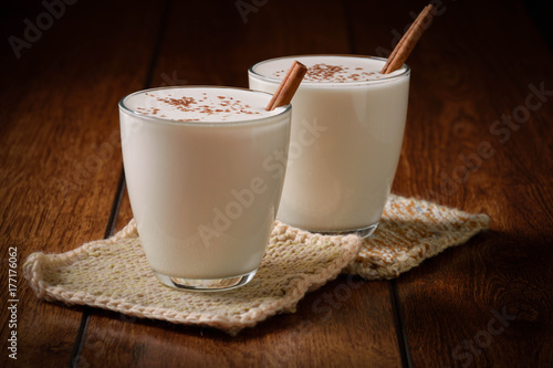 Eggnog houmemade with cinnamon and kakao for Christmas and winter holidays or wooden broun backgrounds