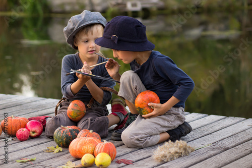Active kids paint small Halloween pumpkins © lanara@bk.ru