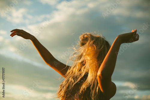 Dances her bliss during sunset