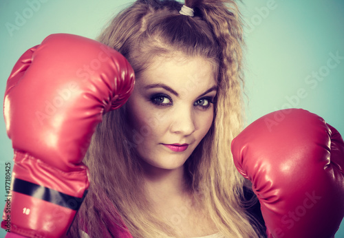Cute girl in red gloves playing sports boxing © Voyagerix