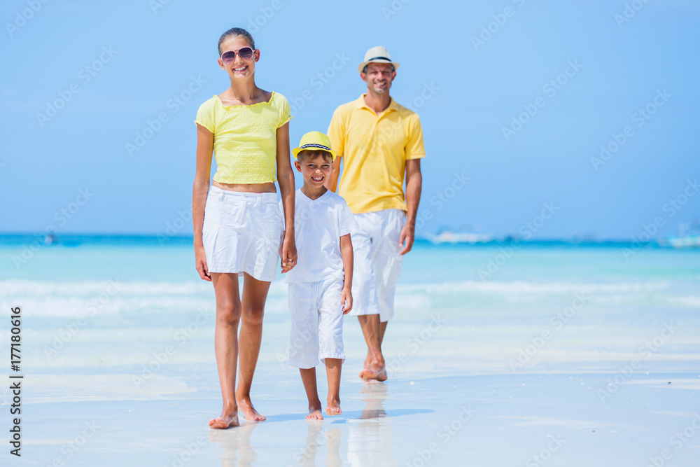 Family of three walking on the beach Family of three walking on the beach