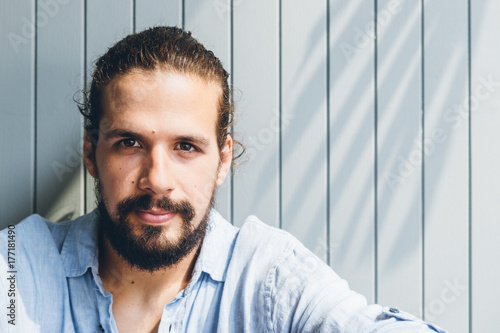 Portrait of a young man with long hair photo