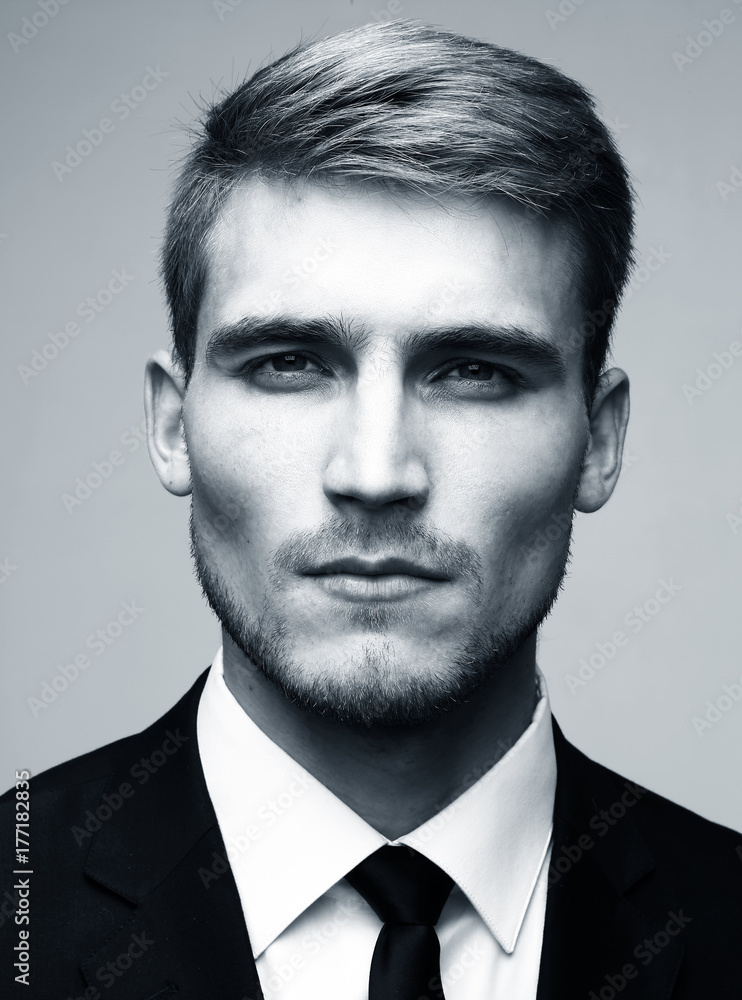 Fototapeta premium Black and white close-up portrait of a successful handsome busin