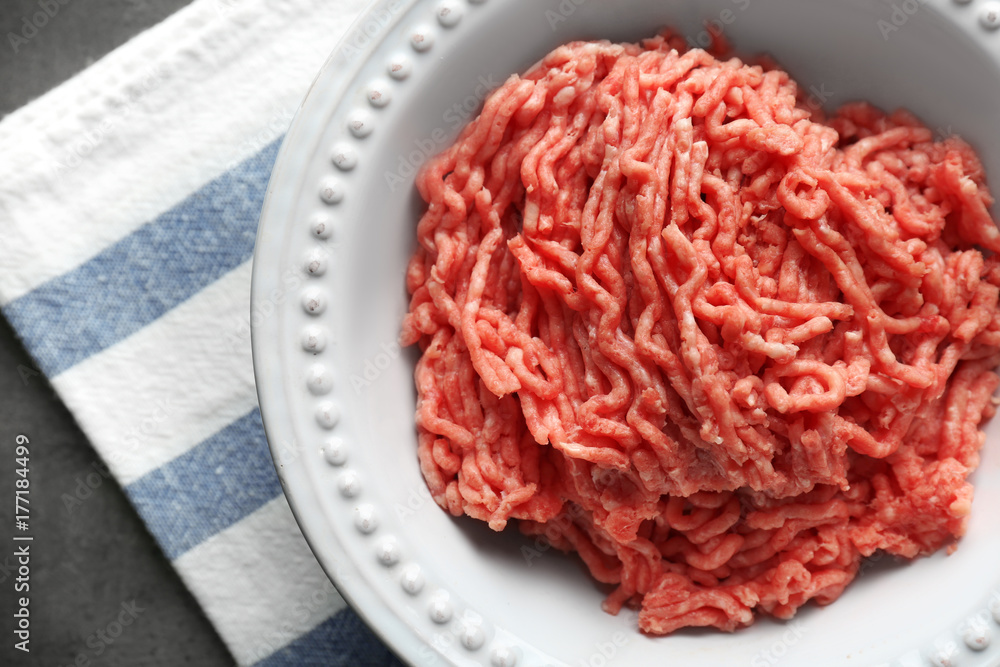 Plate with fresh raw minced meat on table Plate with fresh raw minced meat on table