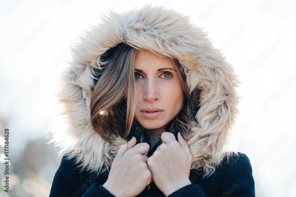 Portrait of a beautiful woman with a fur trim hood over her head Portrait of a beautiful woman with a fur trim hood over her head