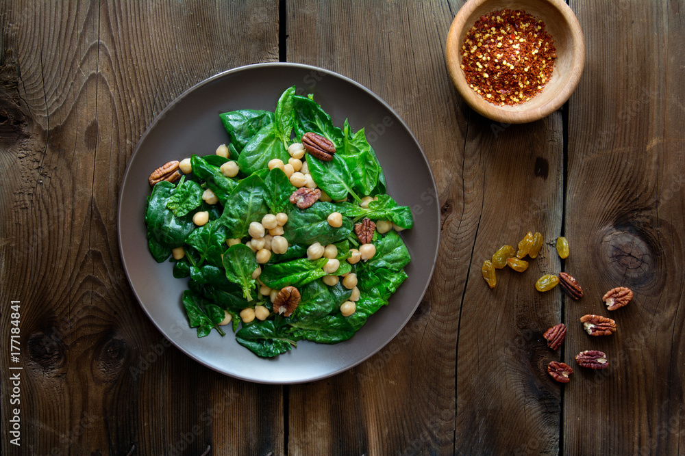 Food: spinach salad with chickpea, pecans and raisins Food: spinach salad with chickpea, pecans and raisins