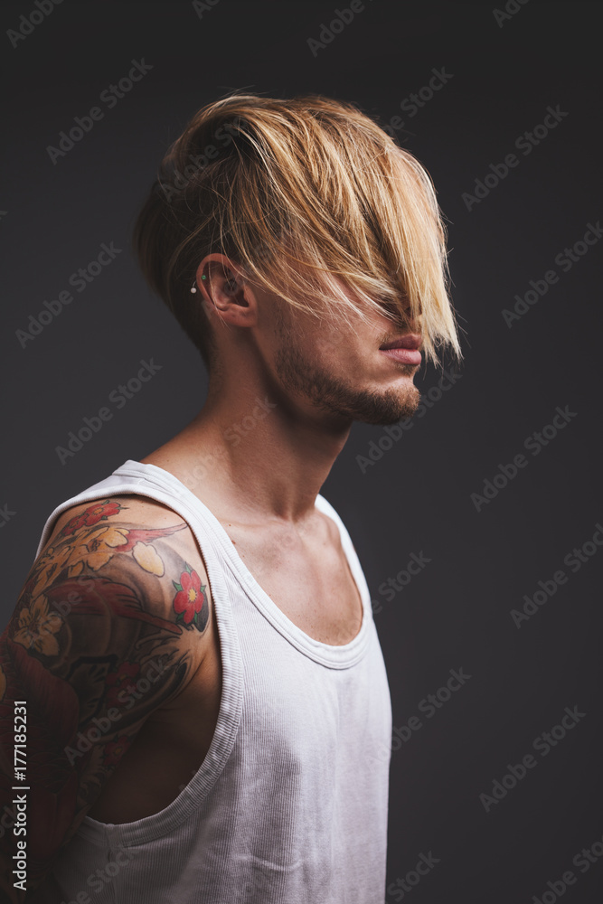 Young man with blond hair covering his face Young man with blond hair covering his face
