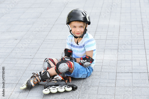 Cute boy on roller skates s...