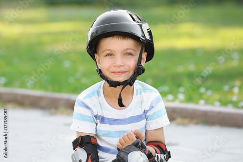 Cute boy in helmet at park