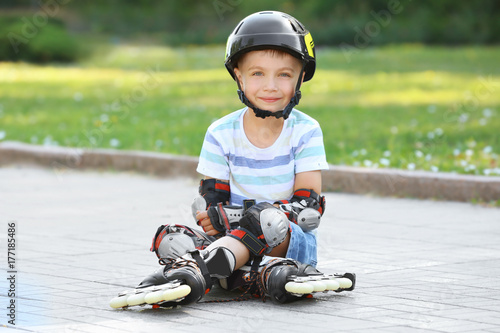 Cute boy on roller skates s...