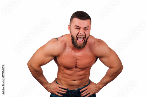 Portrait of a strong bearded male fitness model, torso. White background, isolate. hands on his hips.