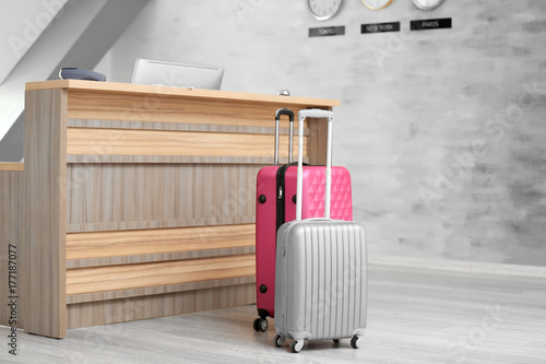Suitcases near reception de...