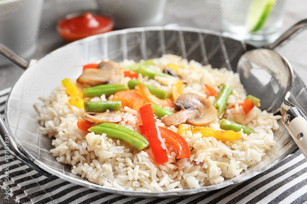 Brown rice with vegetables and mushrooms in frying pan Brown rice with vegetables and mushrooms in frying pan