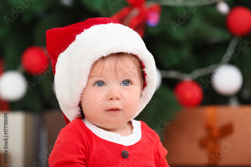 Cute baby in Santa hat agai...