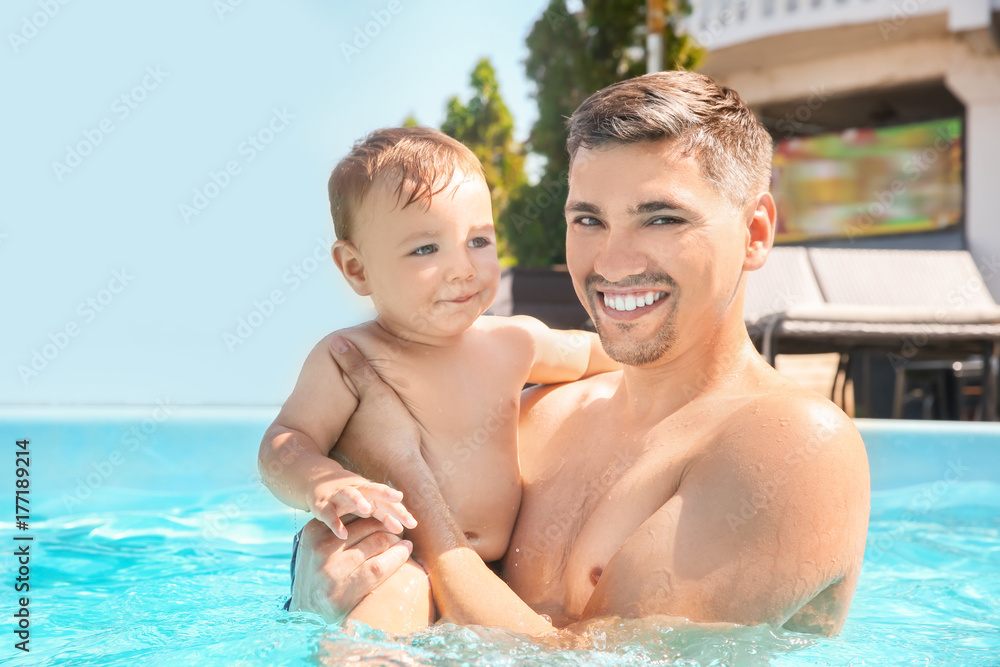 Child swimming lesson. Cute little boy with father in pool