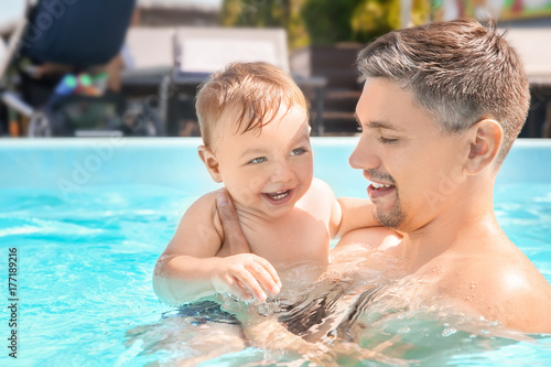 Child swimming lesson. Cute...
