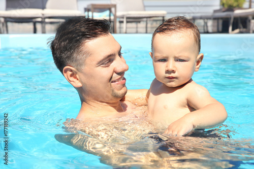Child swimming lesson. Cute...