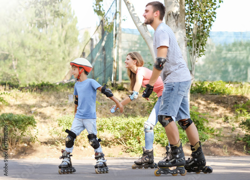 Family rollerskating in park