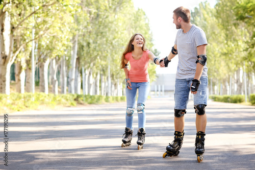 Young couple rollerskating ...