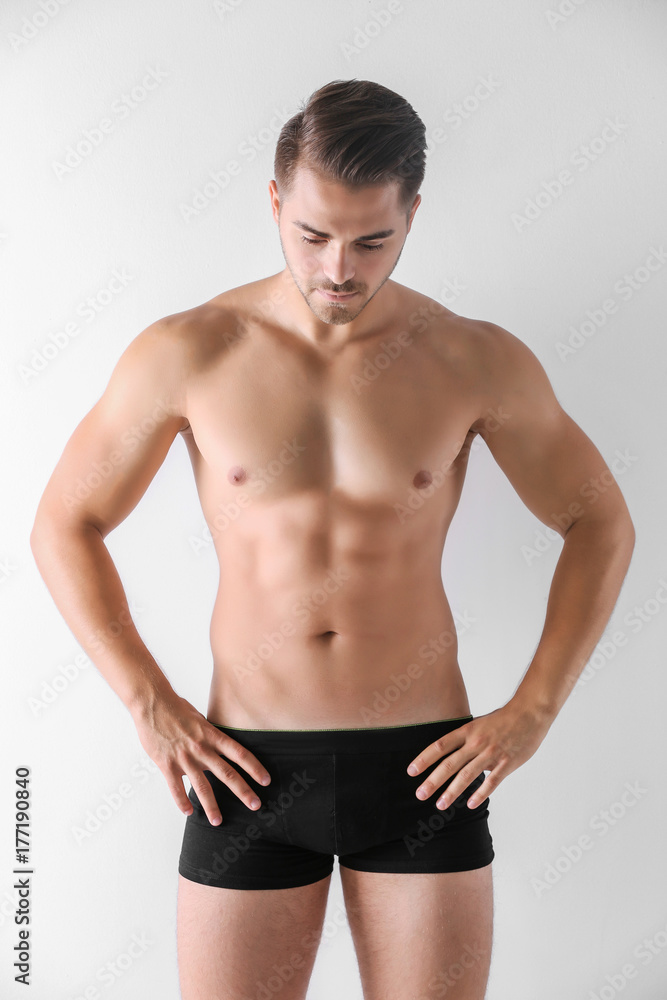 Sexy man in underwear on white background