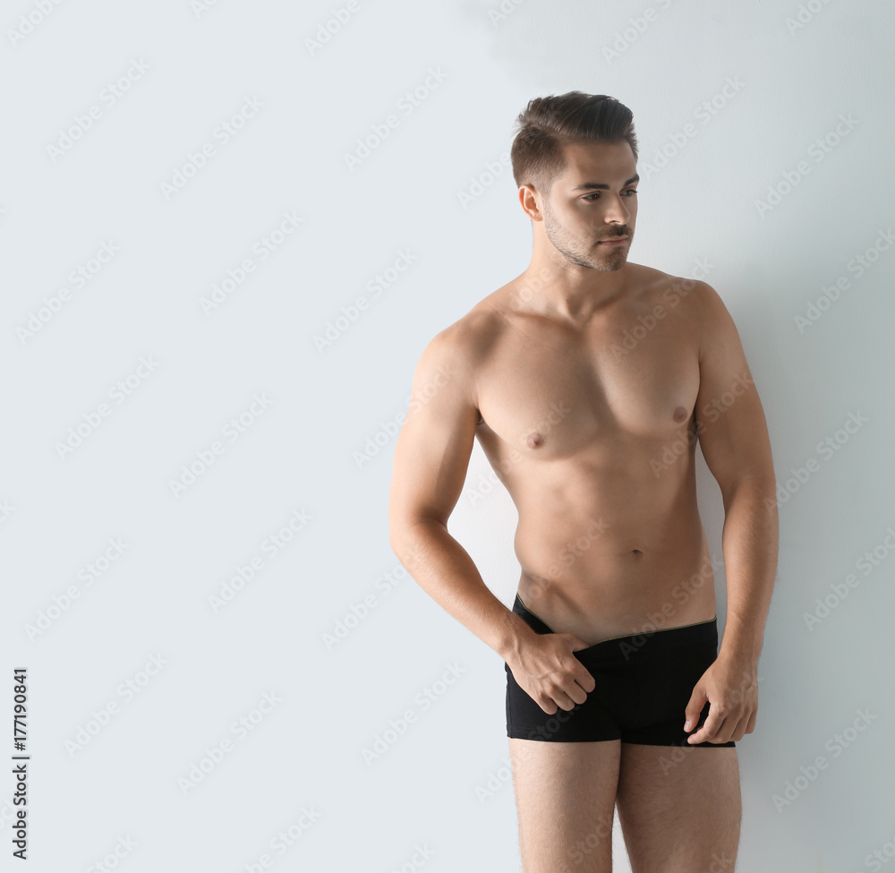 Sexy man in underwear on white background