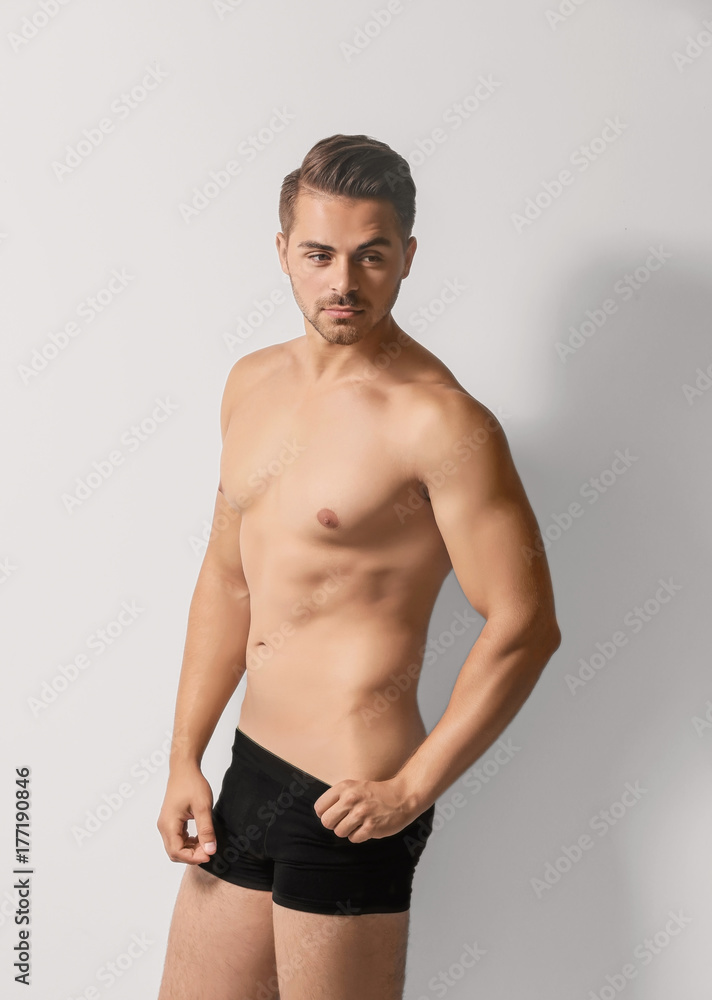 Sexy man in underwear on white background