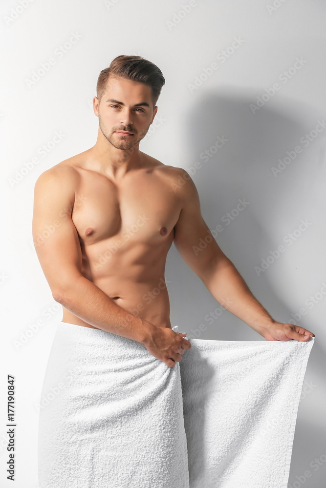 Sexy man wrapping in towel on white background Stock Photo | Adobe Stock