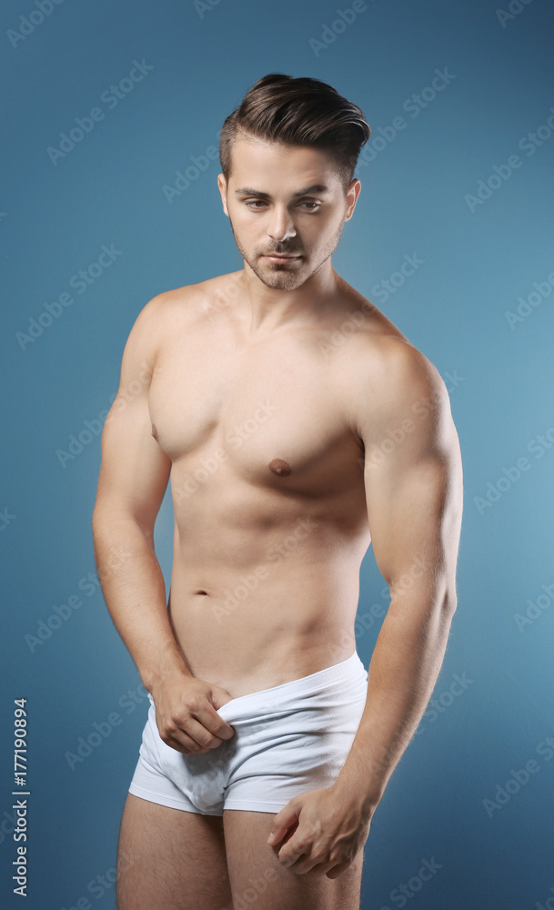 Fototapeta premium Sexy shirtless man in underwear on color background