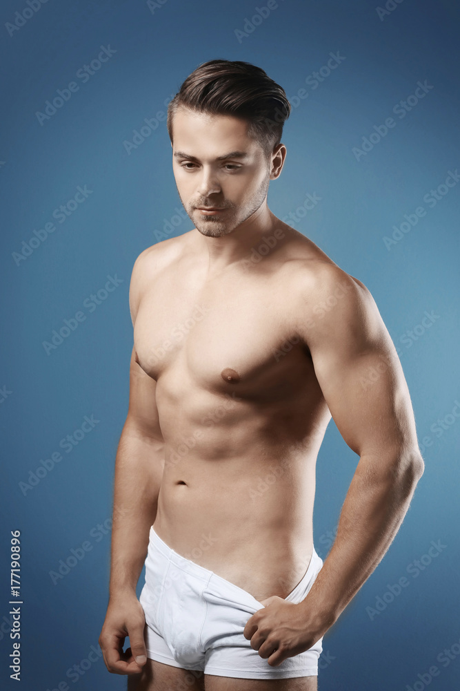 Fototapeta premium Sexy shirtless man in underwear on color background