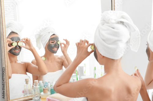 Young women with facial mas...