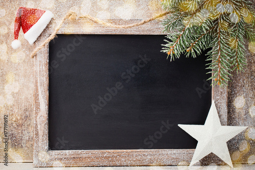 Christmas chalkboard with decoration. Santa hat, stars, Wooden Background. Vintage Rustic Style.
