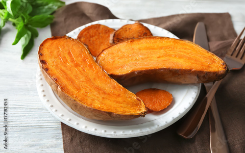 Plate with cooked sweet potato on table