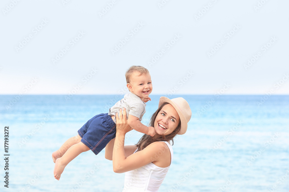 Happy mother with little son on beach Happy mother with little son on beach