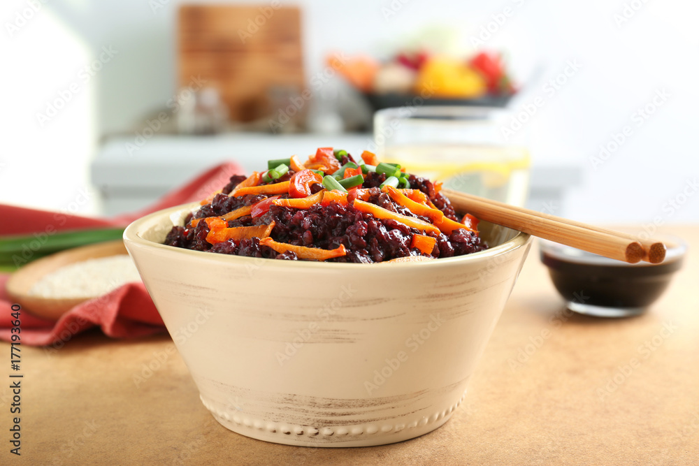 Dish with red rice on table Dish with red rice on table