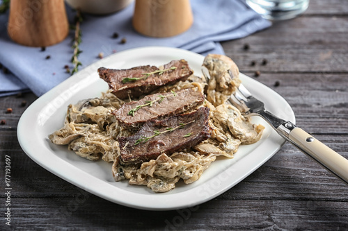 Plate with steak Diane on table photo