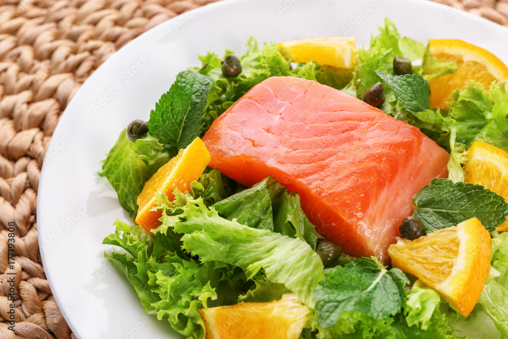 Plate with delicious salmon salad, closeup