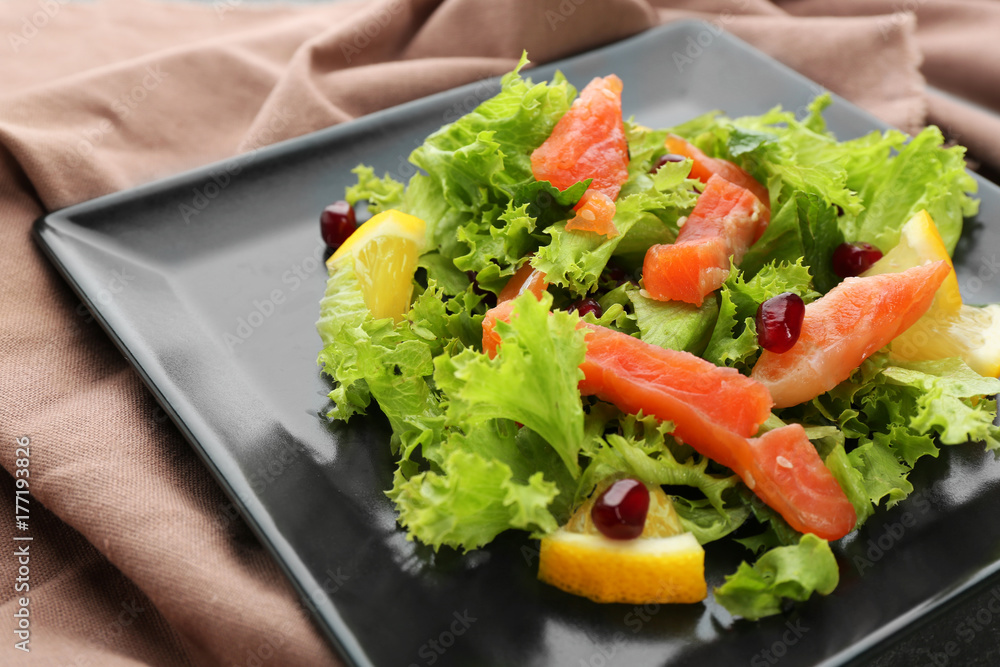 Plate with delicious salmon salad, closeup