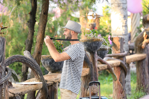 Handsome young tourist taki...