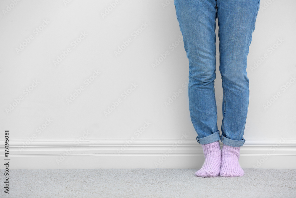 Woman standing on carpet near white wall Woman standing on carpet near white wall