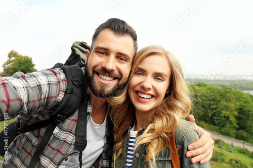 Happy young tourists taking...